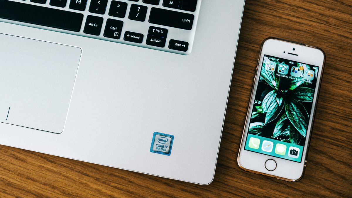 ノートパソコンとスマートフォンを並べた机